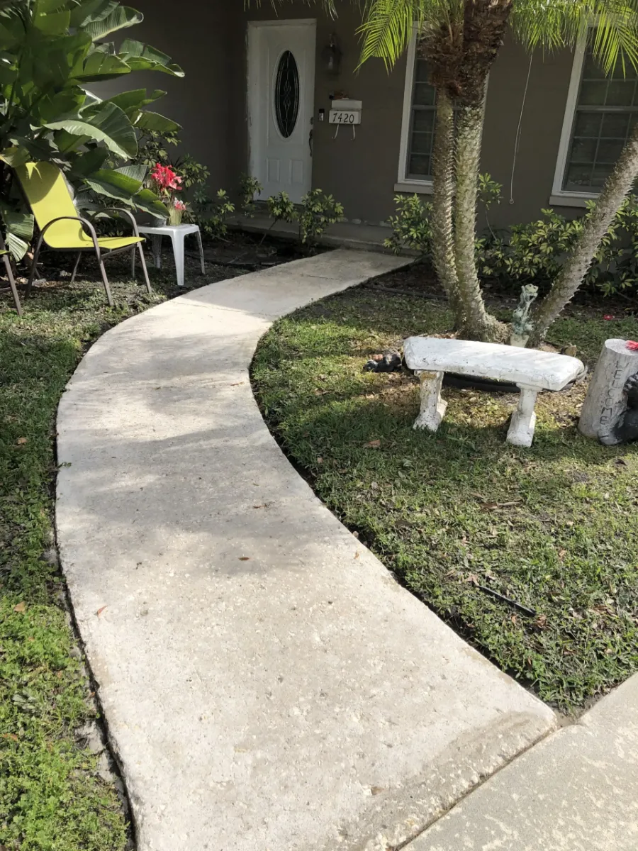 Clean concrete walkway after pressure washing